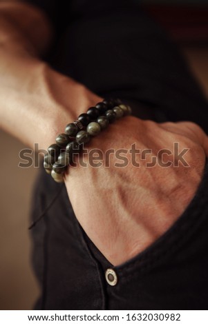close-up bracelets on a guy’s hand