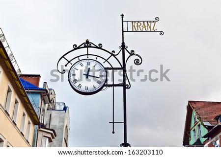 Street clock on the background of the roofs of the old houses. Zelenogradsk (before 1946 Cranz), Kaliningrad oblast, Russia