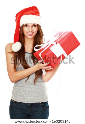 Christmas woman holding gift wearing Santa hat. Isolated on white background