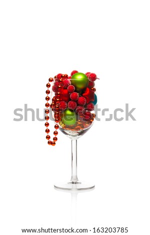 Christmas balls in a vine glass isolated on white.