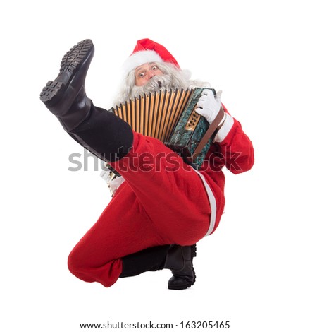 Santa Claus dancing traditional dance cossack isolated on white background. Christmas Concert Santa Claus. Funny Santa musician plays the accordion.