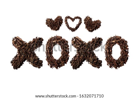 XOXO quote and hearts made with dried tea leaves placed on white background from the top view can use for your messages