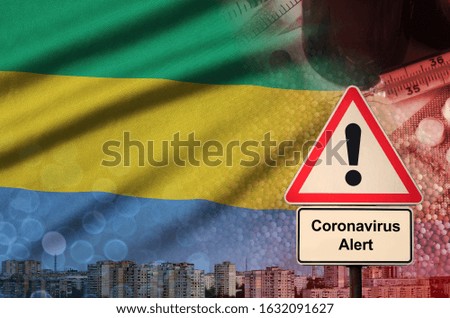 Gabon flag and Coronavirus 2019-nCoV alert sign. Concept of high probability of novel coronavirus outbreak through traveling tourists