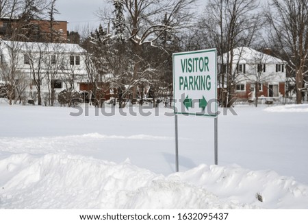 Visitor parking signpost in winter