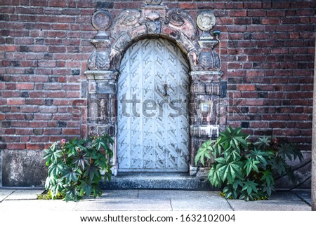 old beautiful entrance with vintage door and brick wall