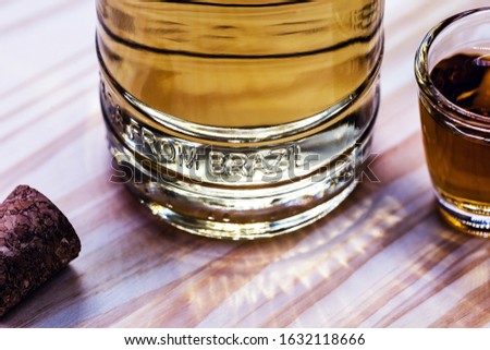 Detail of a bottle of cachaça, a typical Brazilian drink. Brazilian product for export, distilled drink known as aguardente or pinga. Day of cachaça. Royalty-Free Stock Photo #1632118666