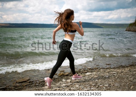 Side view young woman running and jumping outdoors