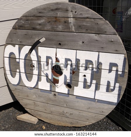Coffee sign on a wooden background.