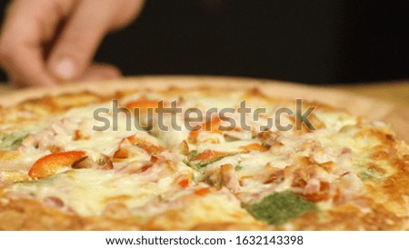 Close-up of juicy pizza with melted cheese. Stock footage. Middle of juicy mouth-watering pizzas with cuts in Italian pizzerias