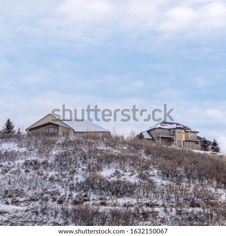 Photo Square frame Residential area on a hill top covered with fresh snow on a cold winter day