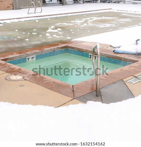 Photo Square Childrens pool and frozen adult swimming pool surrounded by snow in winter