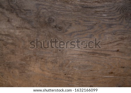 Wooden background from an old board with stains of dark brown color. Wood texture with copy space