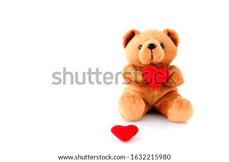 Teddy Bear Holding a heart-shaped on white background
