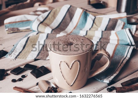 Cup of hot cocoa with marshmallows and cinnamon sticks on wooden background. Love. Cocoa drink. Valentines day treat ideas.