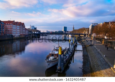 The promenade on the Weser in Bremen with ships on the pier