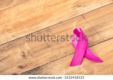 Pink ribbon for breast cancer awareness, symbolic bow color raising awareness on people living with women's breast tumor illness
