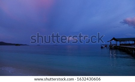 Wooden jetty on a tropical island with cloudy sky.Raja Ampat, West Papua, Indonesia
