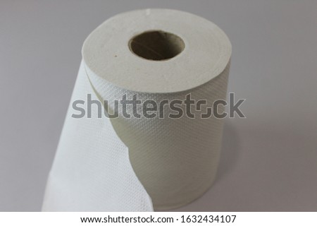 A roll of paper tissue. Toilet paper tissue on white table. isolated image.