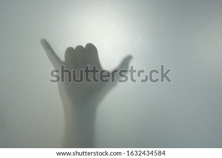 
Blurred Shadow Halloween Concept,silhouette hands behind the mirror Abstract style,Two open hands in the mist. Illustration of designer,Thumbs up the little finger,Buffalo Ideas.