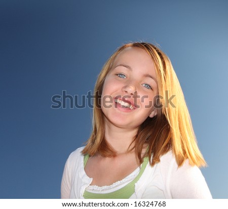 Beautiful Blue Eyed Young Girl Against Blue Sky