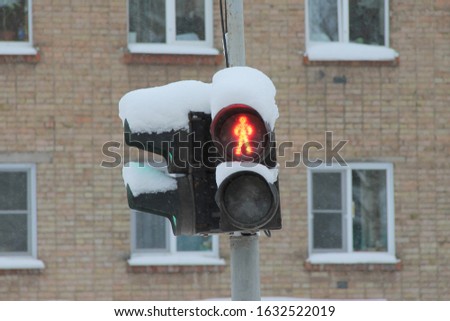 Traffic light for pedestrians with a red light in the shape of a human figure on a pillar in the city. Scenic travel background. Highway transportation concept.