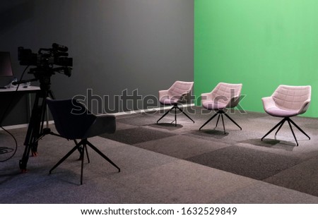 Three empty chairs in a TV studio with green screen Royalty-Free Stock Photo #1632529849