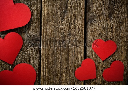 Flat mood photo of paper hearts on wooden retro board with shadows.Copy space for your decoration and Valentine's Day backgorund 