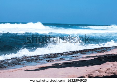 beach, landscape format picture and background. The waves on the beach in blue water and blue sky. Beach with blurry focus