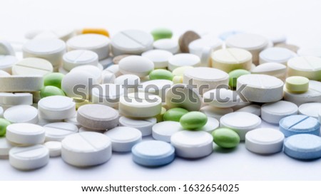 tablets of different shapes and colors on a white background close-up, soft focus