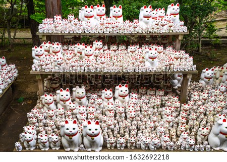 Thousands of maneki-neko statues displayed in the garden of Gotokuji Temple in Tokyo, Japan Royalty-Free Stock Photo #1632692218