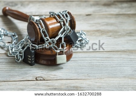 Law and legislation obstruction concept with judge wooden hammer or gavel surrounded by chains and locks Royalty-Free Stock Photo #1632700288