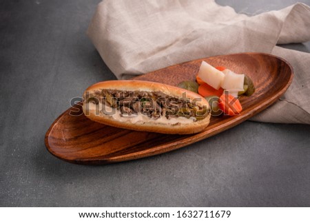 Chicken liver sandwich, sautéed in oil, rich with flavors on a wooden plate and grey background. Royalty-Free Stock Photo #1632711679