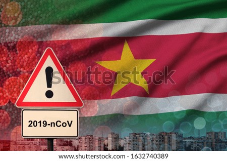 Suriname flag and Coronavirus 2019-nCoV alert sign. Concept of high probability of novel coronavirus outbreak through traveling tourists