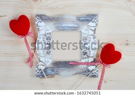 Photo frame and decorative red hearts for Valentine's Day. Holiday card for lovers.