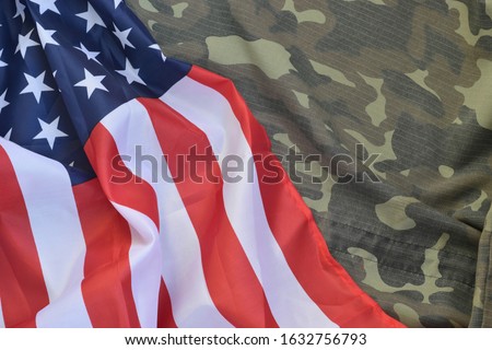United States of America flag and folded military uniform jacket. Military symbols conceptual background banner for american patriotic holidays