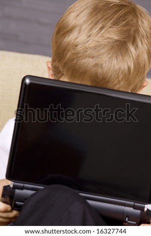 picture of  boy with black laptop computer