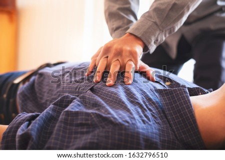 Young business man hand pump on chest for first aid emergency CPR. Royalty-Free Stock Photo #1632796510