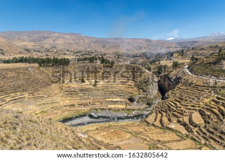 An aerial shot of the beautiful Colca Canyon under the blue sky captured in  Peru