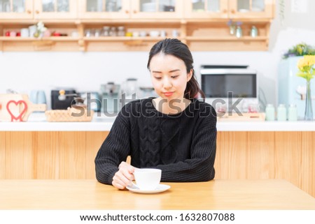 Young woman drinking coffee at home