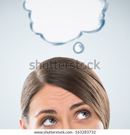 Beautiful caucasian business woman have good idea, including thought bubble with copy space on grey background