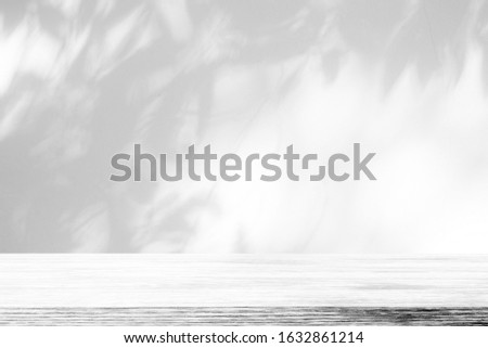 White Wood Table with Tree Shadow on Concrete Wall Texture Background, Suitable for Product Presentation Backdrop, Display, and Mock up.
