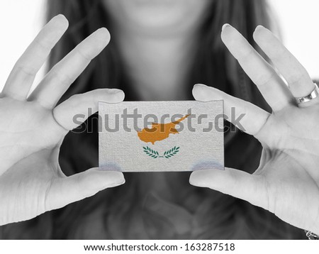 Woman showing a business card, flag of Cyprus