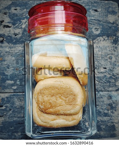 A picture of bagel cookies inside a jar.