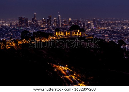 An Observatory at night with downtown LA skyline