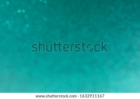 Turquoise background blurred with bokeh.