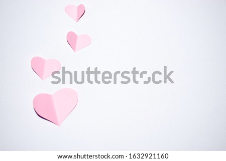 Pink paper heart with white background.Valantines day background.