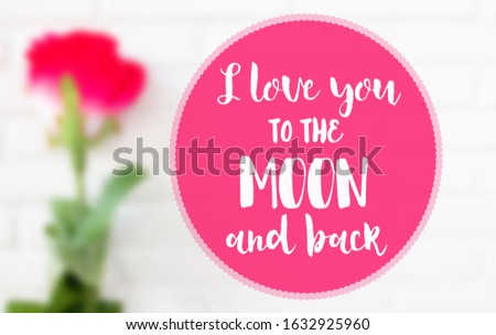 I love you to the moon and back words on blurred image of red rose on white floor background.