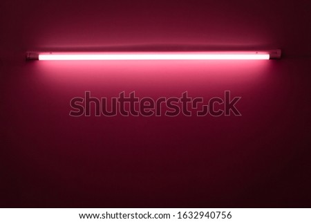 Pink neon lamp on a white wall