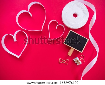flat lay of valentine concept, ribbon shaped heart on red background with blank space for text.