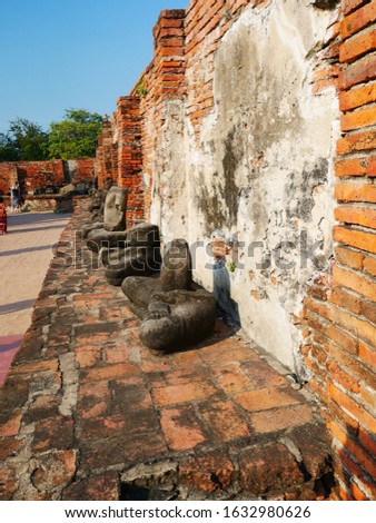 30/12/2019 Travel to Bangkok, Thailand.  A temple with a sandstone Buddha head at the roots of trees in Ayutthaya Wat Mahata, Thailand.